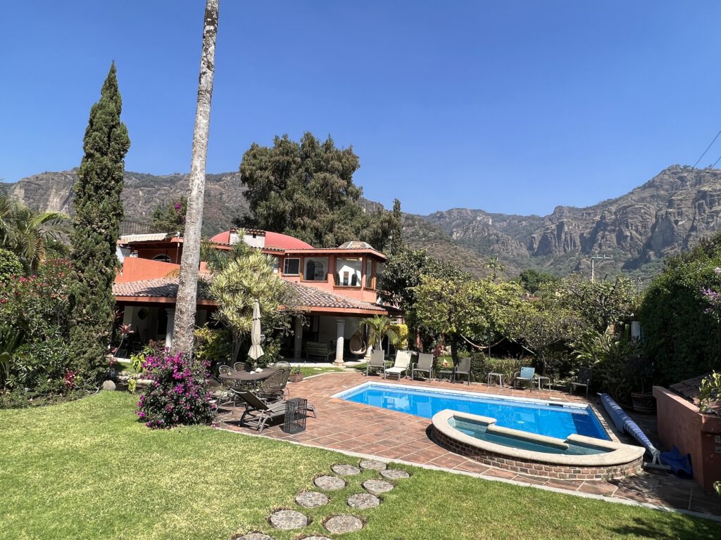The IbogaQuest treatment house, garden and pool with the mountains of Tepoztlán behind