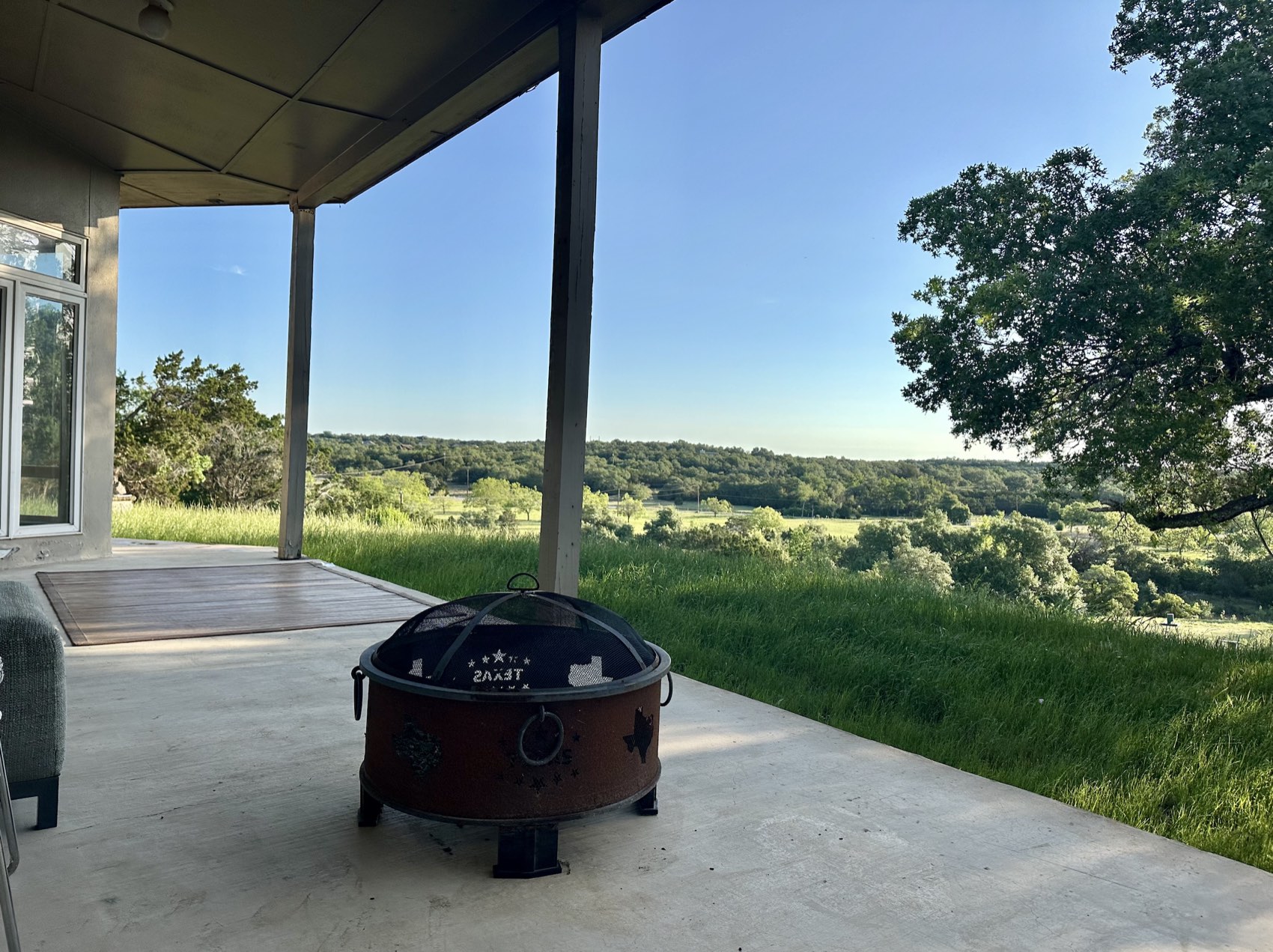 Covered porch with a fire pit overlooking the Texas Hill Country
